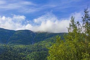 Incredible norwegian landscape with mountains clouds waterfall Jotunheimen Norway photo