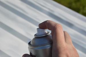 Roof painting with enamel paint from an aerosol can photo