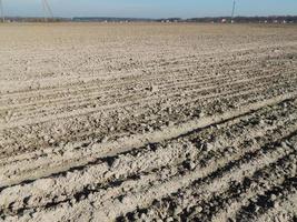 Tractor plowed field and arable land photo