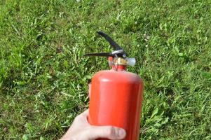 Handheld fire extinguisher to protect home and interior from fire photo