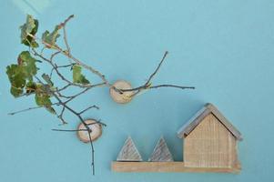 Wooden model of a house and family photo