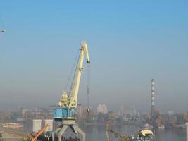 Port cranes for cargo transportation in the port logistics complex photo