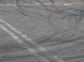 Manchas de neumáticos de automóviles en tarjetas de carreras de asfalto foto