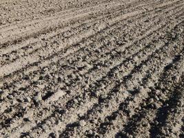tractor arado campo y tierra cultivable foto