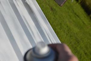 Roof painting with enamel paint from an aerosol can photo