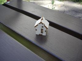 Wooden house stands on a bench photo