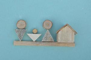 Wooden model of a house and family photo