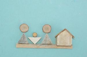 Wooden model of a house and family photo