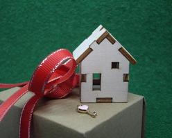 Receiving keys to his apartment building on a background of green grass photo