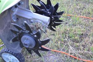 Cultivator for plowing soil and planting seeds photo