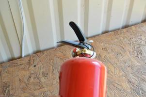 Handheld fire extinguisher to protect home and interior from fire photo