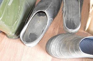 There are old shoes for the garden and vegetable garden in the village photo