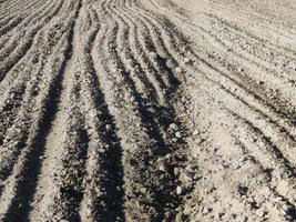 Tractor plowed field and arable land photo