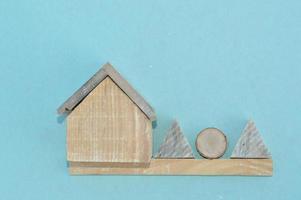 Wooden model of a house and family photo