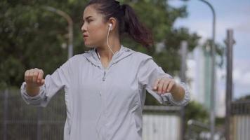 Asian fitness runner sportswomen stretching and preparing in the urban city to run. video