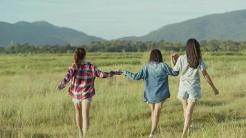 Asian women holding hands walking having fun together a summer traveling.