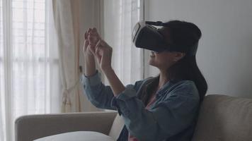 Asian woman wearing VR headset at living room. video
