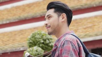 Asian man tourists traveling and taking a photo in temple Thailand. video