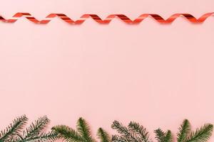 Minimal creative flat lay of christmas traditional composition and new year holiday season. Top view winter christmas decorations on pink background with blank space for text. Copy space photography. photo