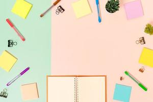 Creative flat lay photo of workspace desk. Top view office desk with keyboard, mouse and open mockup black notebook on pastel green pink color background. Top view mock up with copy space photography.