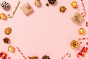 Minimal creative flat lay of christmas traditional composition and new year holiday season. Top view winter christmas decorations on pink background with blank space for text. Copy space photography. photo