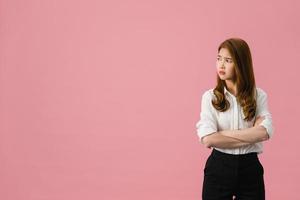 Young Asia lady with negative expression, excited screaming, crying emotional angry in casual clothing and looking at space isolated on pink background. Happy adorable glad woman rejoices success. photo
