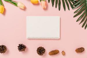 Creative flat lay of travel vacation spring or summer tropical fashion. Top view beach accessories open mockup black notebook for text on pastel background. Top view mock up copy space photography. photo