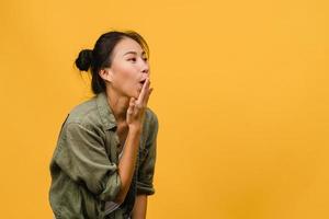 Young Asia lady feel happiness with positive expression, joyful surprise funky, dressed in casual cloth isolated on yellow background. Happy adorable glad woman rejoices success. Facial expression. photo