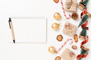 Minimal creative flat lay of winter christmas traditional composition and new year holiday season. Top view open mockup black notebook for text on white background. Mock up and copy space photography. photo