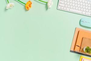 Minimal work space - Creative flat lay photo of workspace desk. Top view office desk with keyboard, mouse and notebook on pastel green color background. Top view with copy space, flat lay photography.