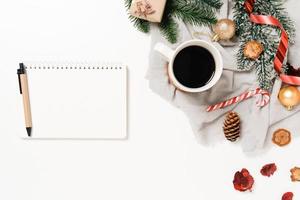 Minimal creative flat lay of winter christmas traditional composition and new year holiday season. Top view open mockup black notebook for text on white background. Mock up and copy space photography. photo