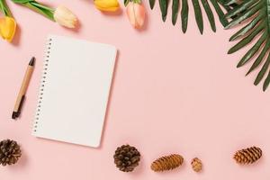 Creative flat lay of travel vacation spring or summer tropical fashion. Top view beach accessories open mockup black notebook for text on pastel background. Top view mock up copy space photography. photo