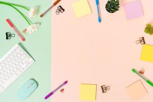 Minimal work space - Creative flat lay photo of workspace desk. Top view office desk with keyboard, mouse and adhesive note on pastel green pink color background. Top view with copy space photography.