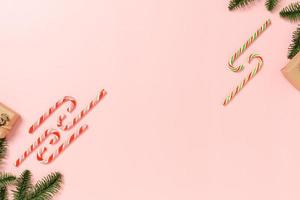 Minimal creative flat lay of christmas traditional composition and new year holiday season. Top view winter christmas decorations on pink background with blank space for text. Copy space photography. photo