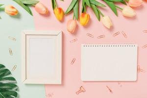 Creative flat lay of travel vacation spring or summer tropical fashion. Top view beach accessories open mockup black notebook for text on pastel background. Top view mock up copy space photography. photo