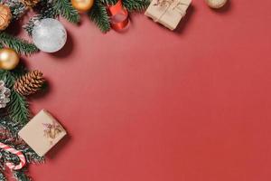 Minimal creative flat lay of christmas traditional composition and new year holiday season. Top view winter christmas decorations on red background with blank space for text. Copy space photography. photo