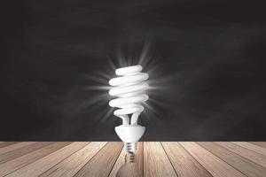 Light bulb on wood background , Idea innovation and inspiration concept, new technology in the future,  brainstorming, and education concepts. photo