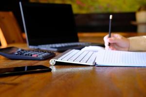 Man hand working on laptop computer on table and home quarantine, new normal photo