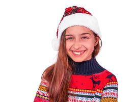 Portrait of a little laughing girl in santa hat. Concept for Christmas holidays and Happy New Year. photo