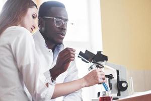Scientists work closely with the microscope in the laboratory by conducting experiments and analyzes. photo