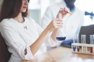 Scientists work closely with the microscope in the laboratory by conducting experiments and analyzes. photo
