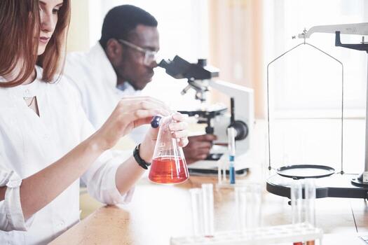 Laboratory laboratories conduct experiments in a chemical laboratory in transparent flasks. Output formulas photo