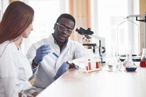 Scientists work closely with the microscope in the laboratory by conducting experiments and analyzes. photo