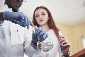 Experiments in the chemical laboratory. An experiment was carried out in a laboratory in transparent flasks photo