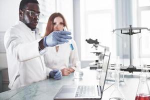 Laboratory laboratories conduct experiments in a chemical laboratory in transparent flasks. Output formulas photo