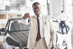 The young attractive black businessman buys a new car, dreams come true photo