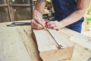 A man works in a joiner's shop, working with a tree. photo