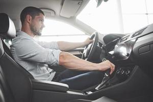 Attractive bearded happy man in good car photo