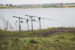 Carp fishing rods standing on special tripods. Expensive coils and a radio system of crochet photo