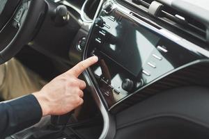 Man includes an audio system in the car. photo